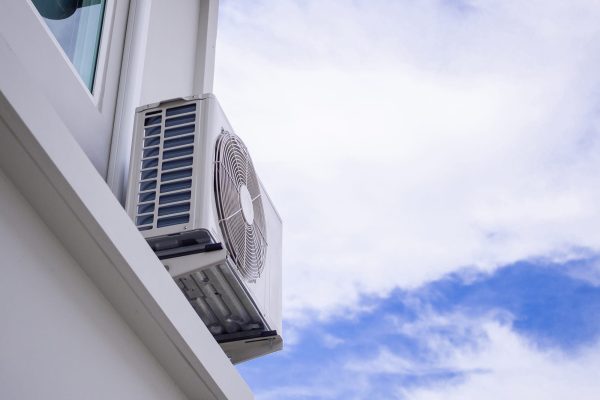women hand is regulating the heater/air condition temperature